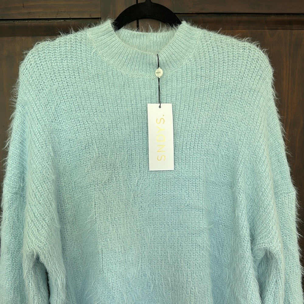 New with tag, never worn, fuzzy baby blue sweater.